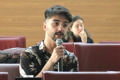 Participante do público faz perguntas aos expositores