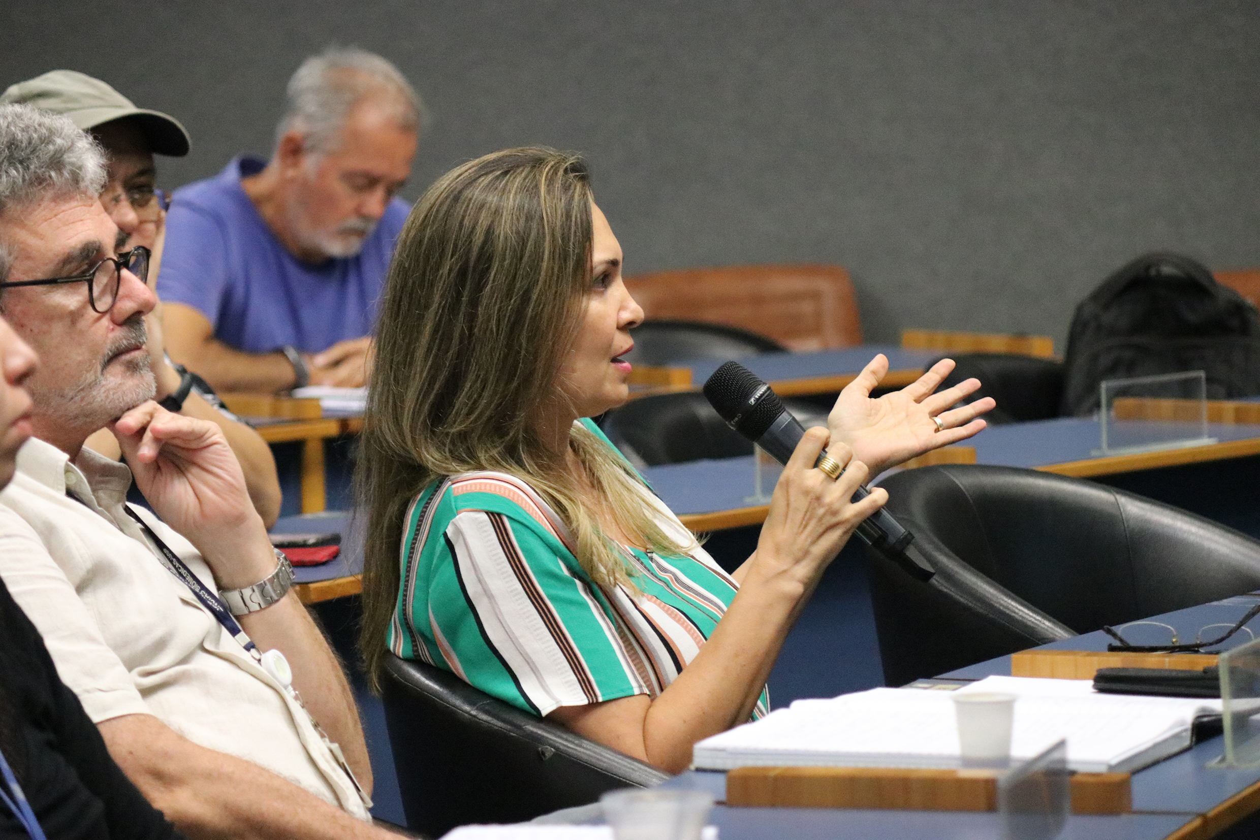 Participante do público faz pergunta aos expositores